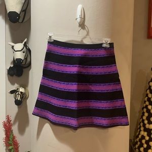 Miami brand mini skirt Sz M. Black with neon pink/blue pattern stripes